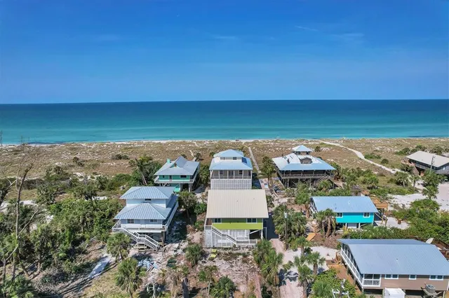 an aerial view of a house with a ocean view