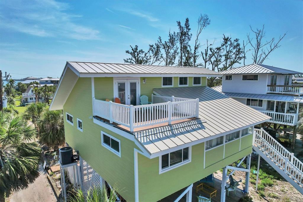 9350 Little Gasparilla Boca Grande, FL 33921 - Photo 2 of 46 a front view of a house with a garden