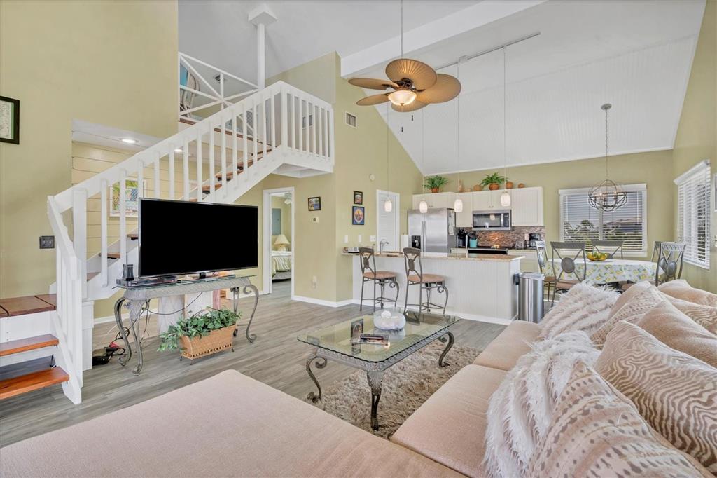 9350 Little Gasparilla Boca Grande, FL 33921 - Photo 24 of 46 a living room with furniture a flat screen tv and kitchen view