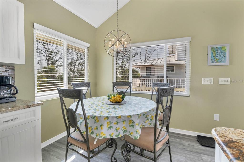 9350 Little Gasparilla Boca Grande, FL 33921 - Photo 30 of 46 a view of a dining room with furniture a chandelier and wooden floor