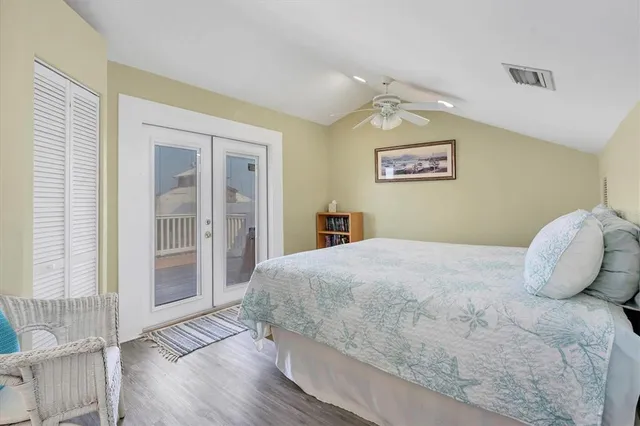 a bedroom with a bed and a ceiling fan