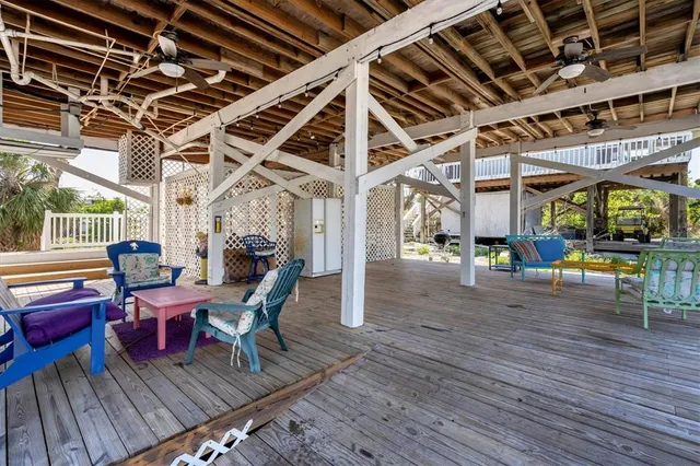a view of a porch with furniture and wooden floor