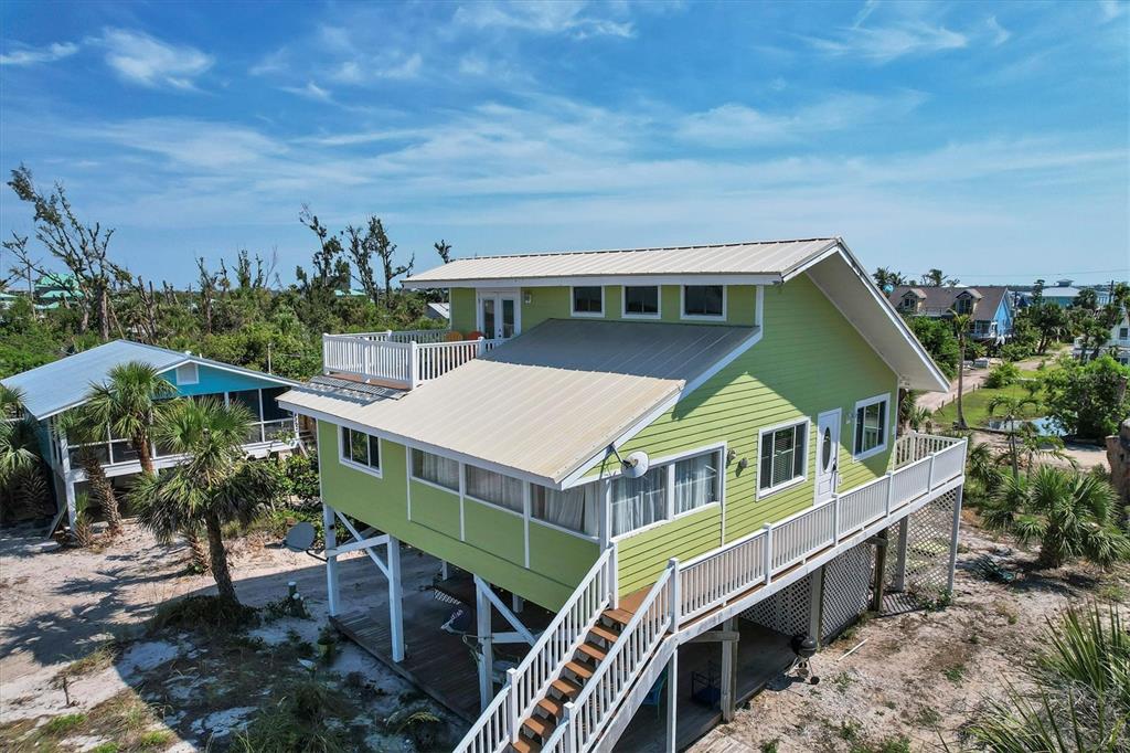 9350 Little Gasparilla Boca Grande, FL 33921 - Photo 4 of 46 a aerial view of a house with a balcony