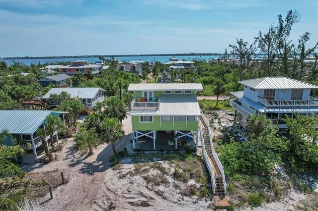 an aerial view of a house with yard swimming pool and outdoor seating