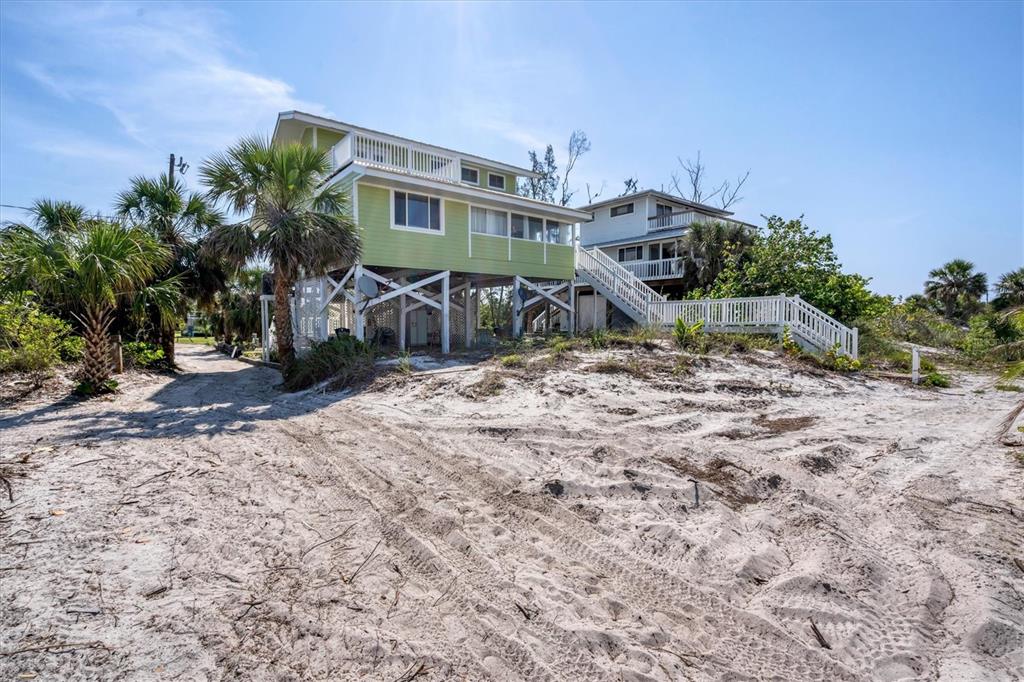 9350 Little Gasparilla Boca Grande, FL 33921 - Photo 8 of 46 a view of a house with backyard and sitting area