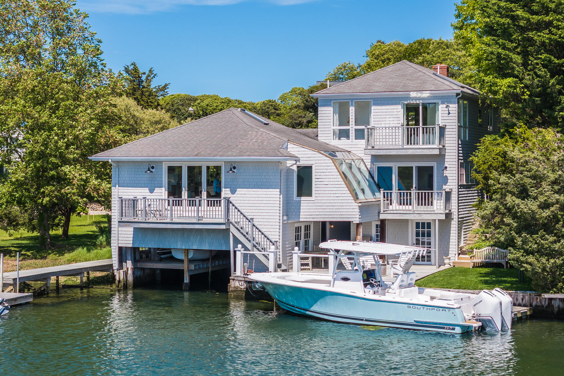 a view of a house with pool table and chairs under an umbrella