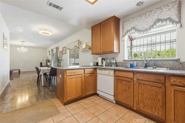 a kitchen with stainless steel appliances granite countertop a sink and cabinets