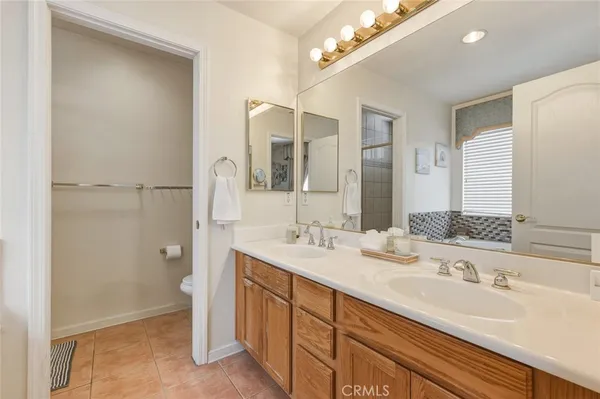 a spacious bathroom with a double vanity sink a mirror and a shower