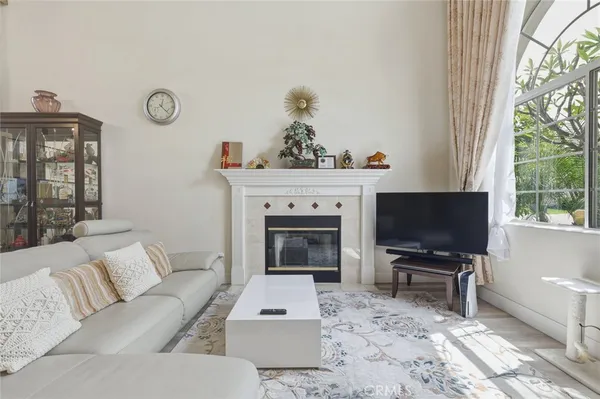 a living room with furniture a fireplace and a flat screen tv