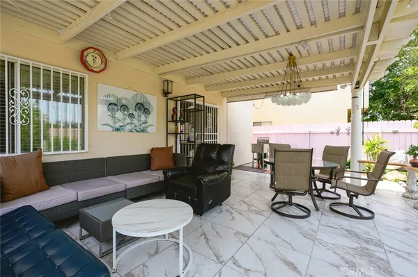 a living room with furniture and a floor to ceiling window