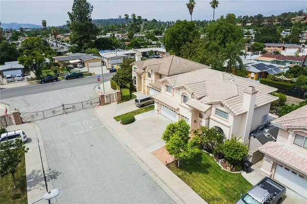 aerial view of a house with yard and mountain view in back