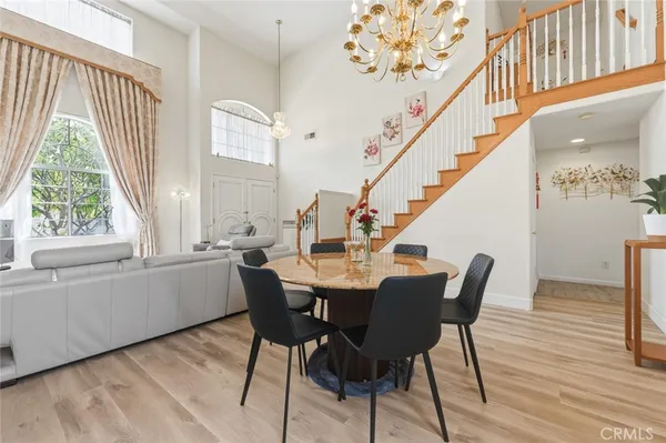 a view of a dining room with furniture and windows
