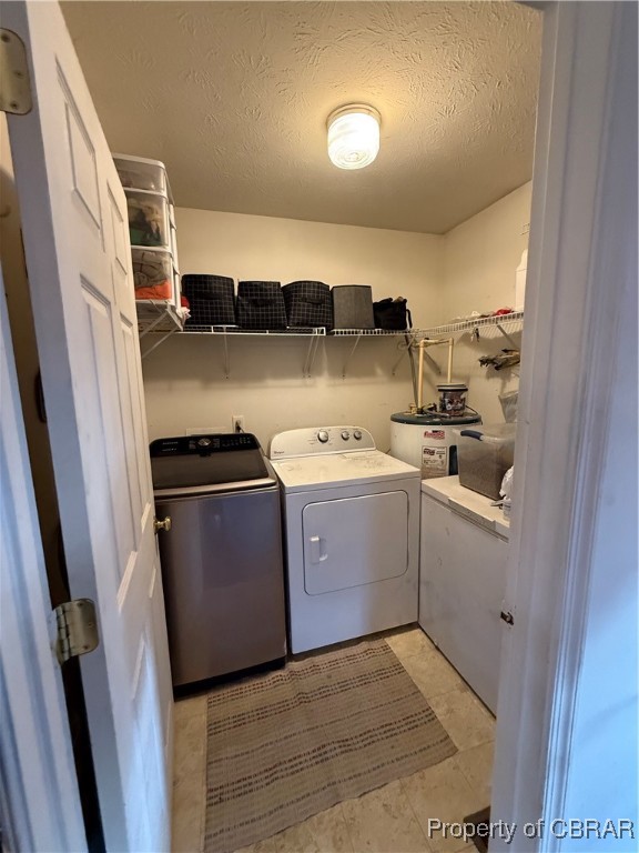 1342 Lewis Level Road Tappahannock, VA 22560 - Photo 6 of 8 Laundry area featuring washing machine and clothes dryer and a textured ceiling