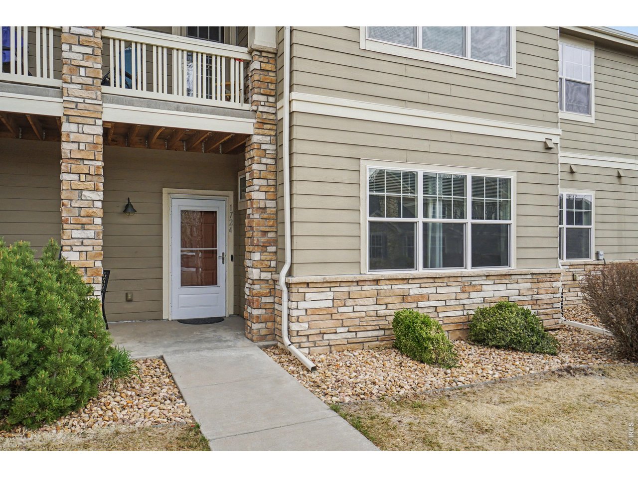 6603 West 3rd Street, Unit 1724 Greeley, CO 80634 - Photo 1 of 23 a front view of a house with a yard