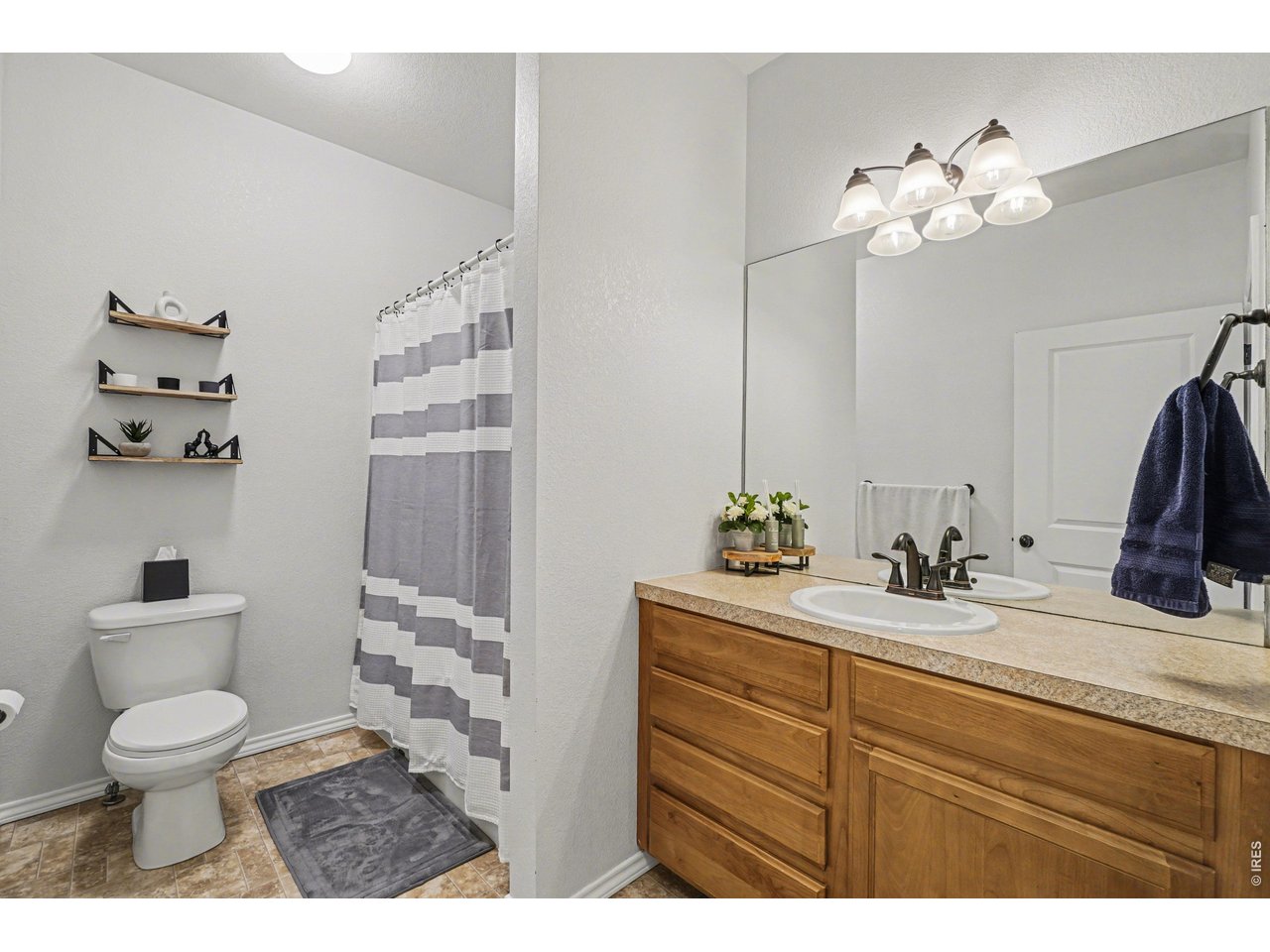 6603 West 3rd Street, Unit 1724 Greeley, CO 80634 - Photo 14 of 23 a bathroom with a toilet a sink and a mirror
