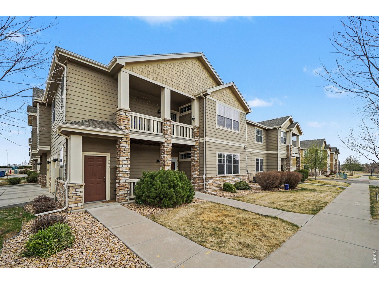 6603 West 3rd Street, Unit 1724 Greeley, CO 80634 - Photo 2 of 23 a front view of a house with a yard