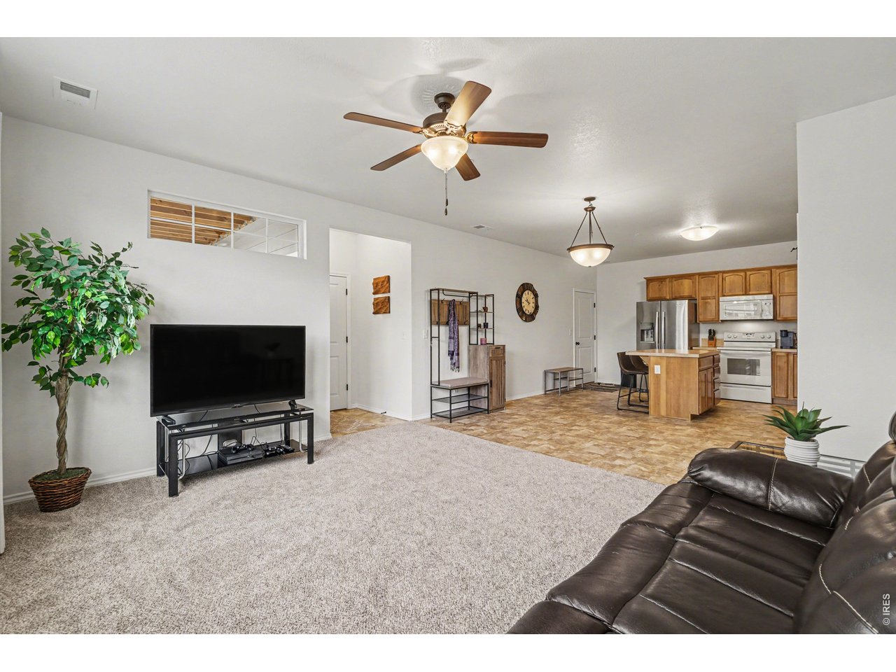 6603 West 3rd Street, Unit 1724 Greeley, CO 80634 - Photo 4 of 23 a living room with furniture and a flat screen tv