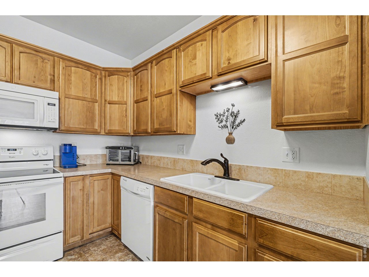 6603 West 3rd Street, Unit 1724 Greeley, CO 80634 - Photo 7 of 23 a kitchen with stainless steel appliances granite countertop a sink a stove and cabinets