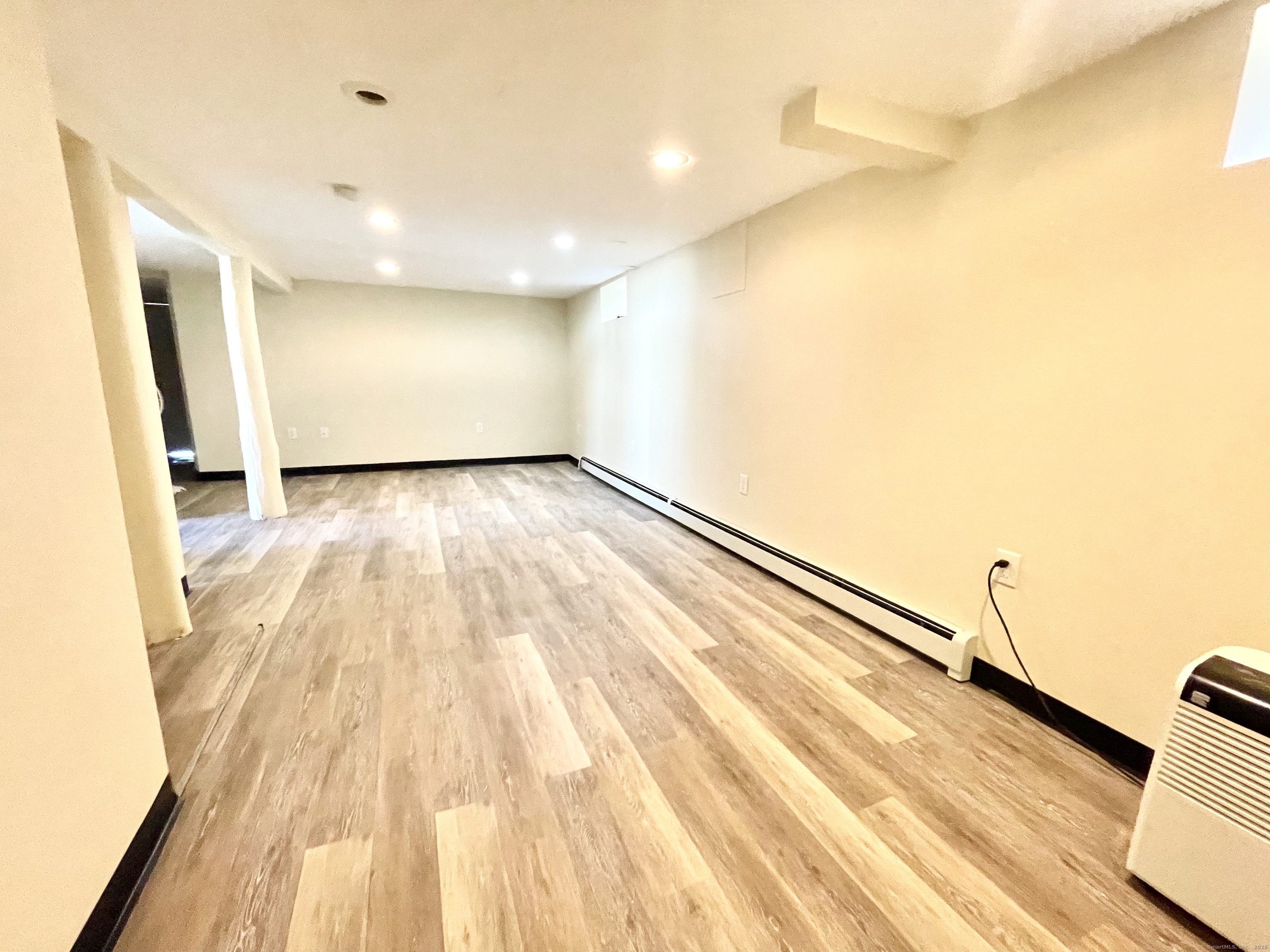 a view of a room with wooden floor