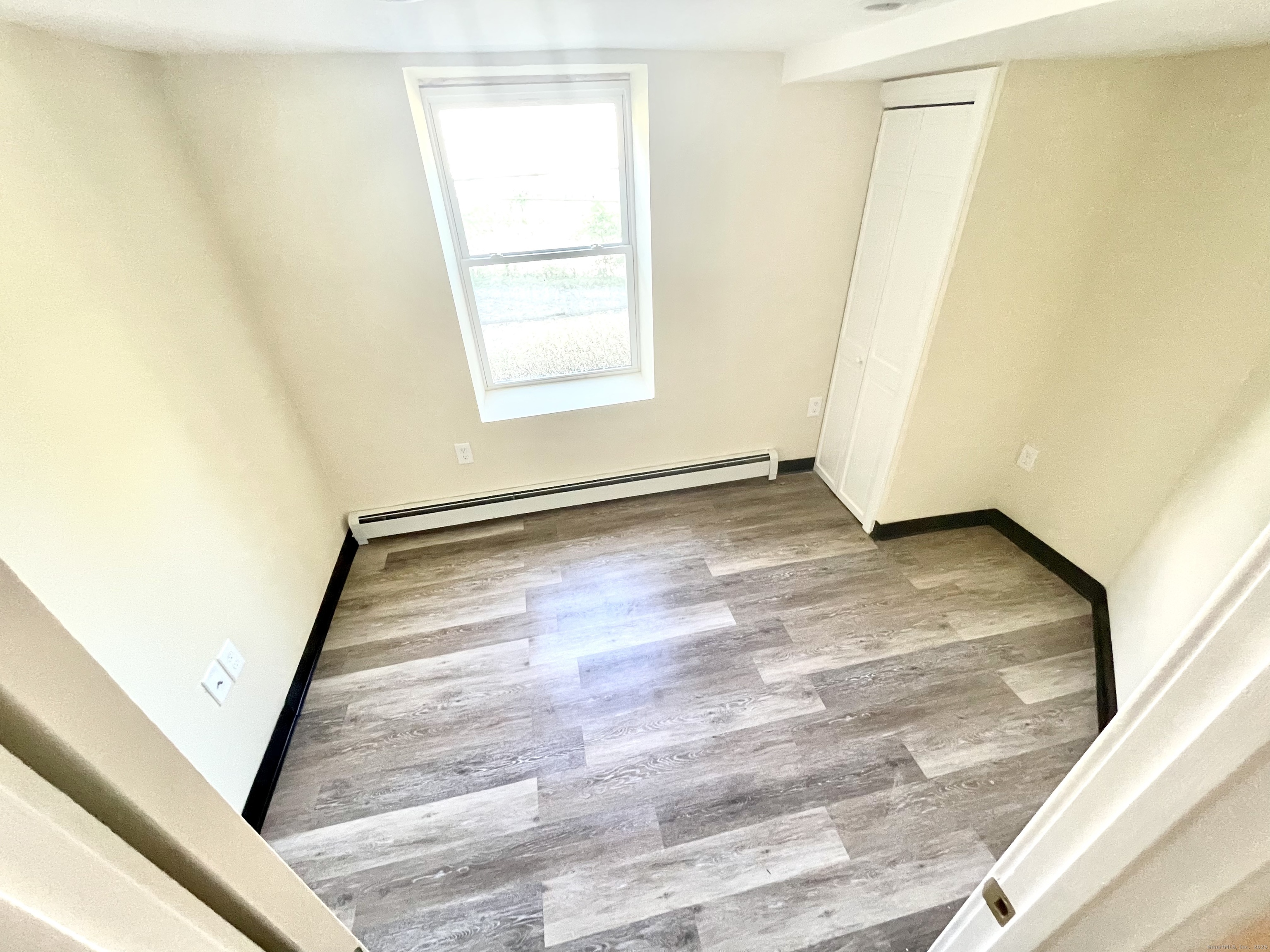 129 Highland Avenue, Unit B Waterbury, CT 06708 - Photo 15 of 17 a view of an empty room and window