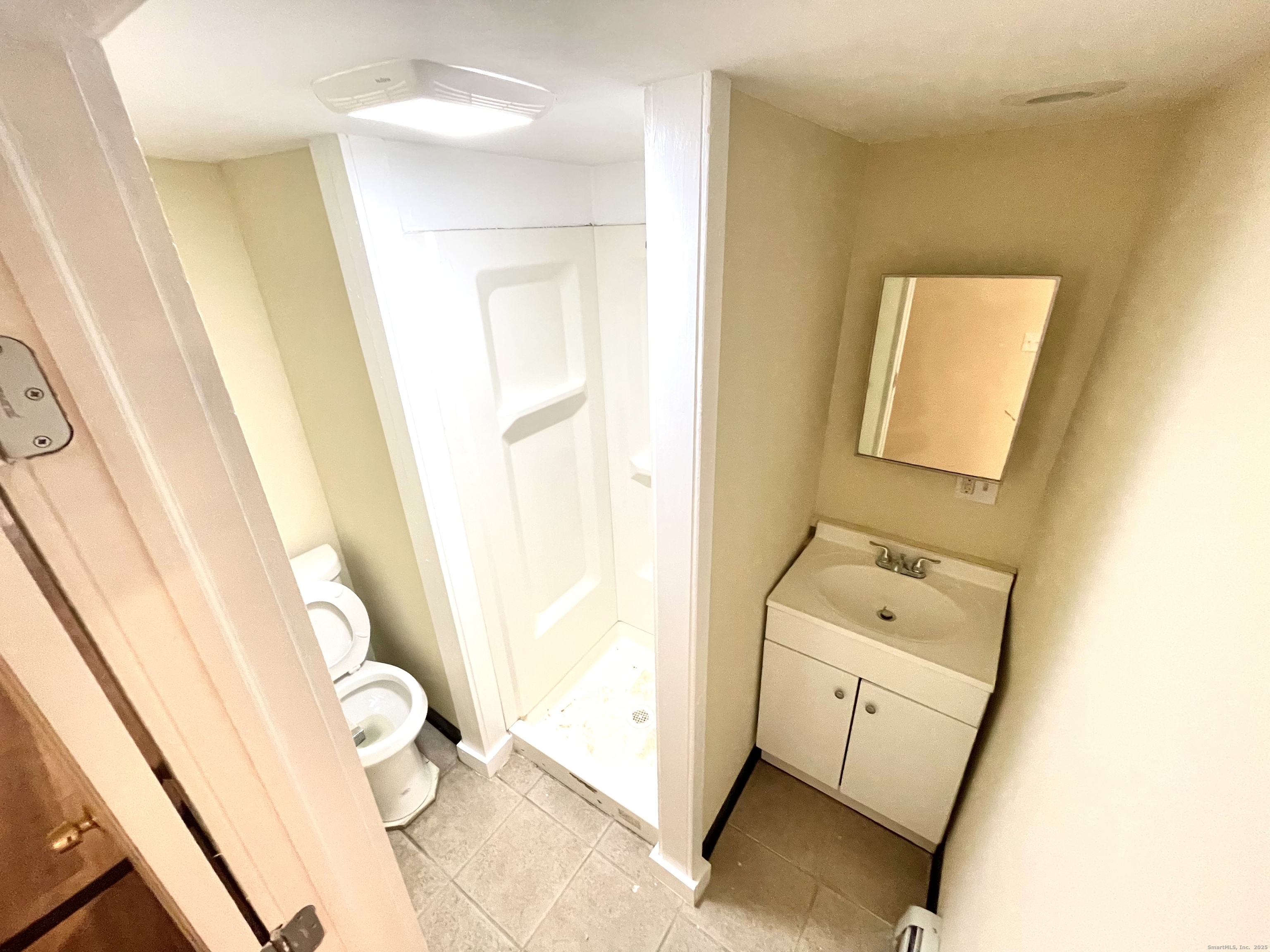 129 Highland Avenue, Unit B Waterbury, CT 06708 - Photo 16 of 17 a bathroom with a sink and mirror