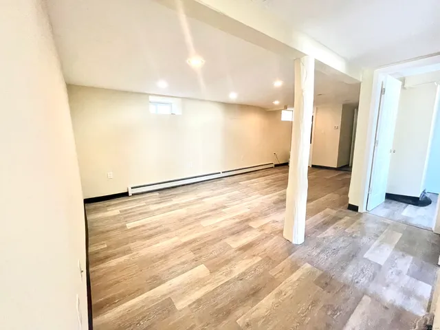 a view of a kitchen with wooden floor and a sink