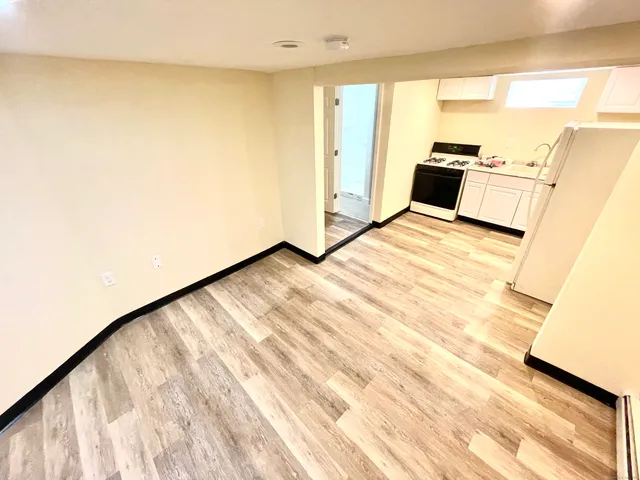 a view of kitchen with refrigerator microwave and stove