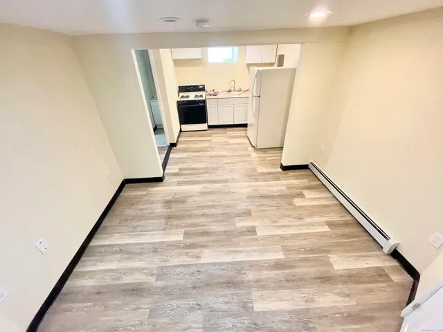 a view of a room with wooden floor and a sink
