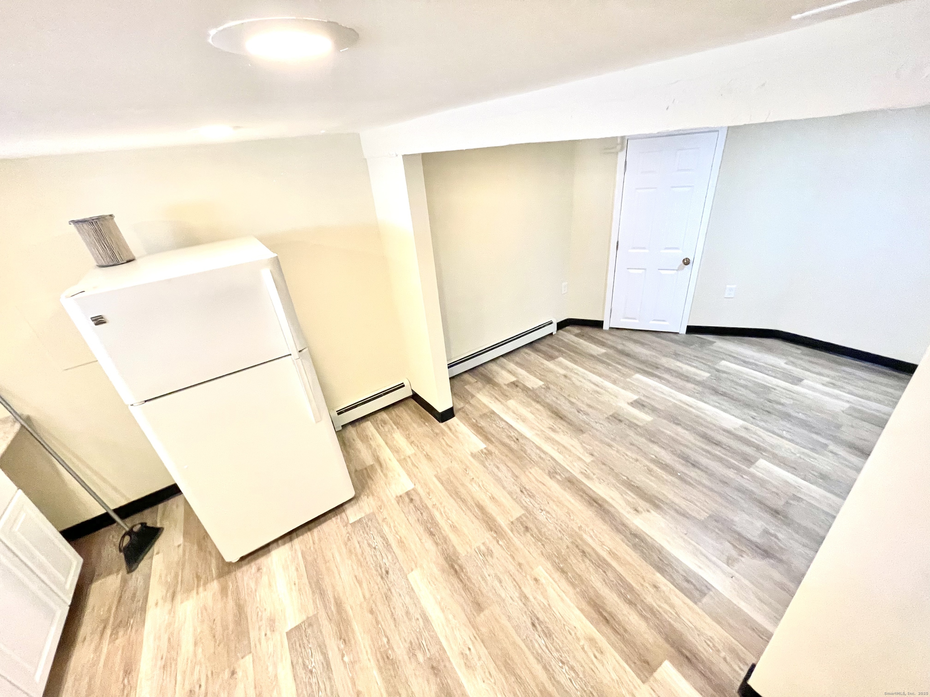 129 Highland Avenue, Unit B Waterbury, CT 06708 - Photo 8 of 17 a view of a room with wooden floor and a sink