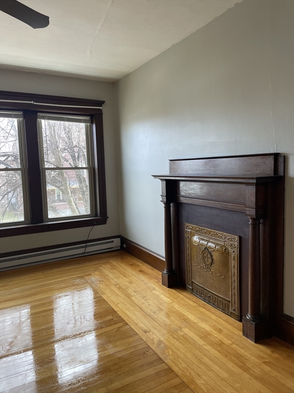 0 Sargeant Street, Unit 3 Holyoke, MA 01040 - Photo 5 of 5 a view of empty room with wooden floor and fan