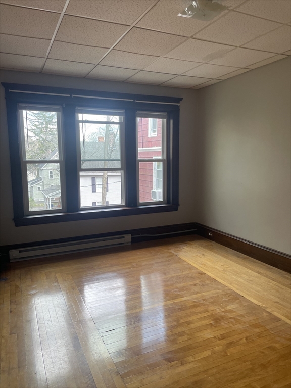 245 Sargeant Street, Unit 2 Holyoke, MA 01040 - Photo 7 of 9 a view of empty room with wooden floor and fan