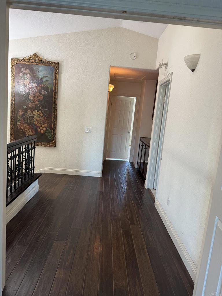 467 Cherry Hills Lane Bonita, CA 91902 - Photo 12 of 42 a view of a hallway with wooden floor