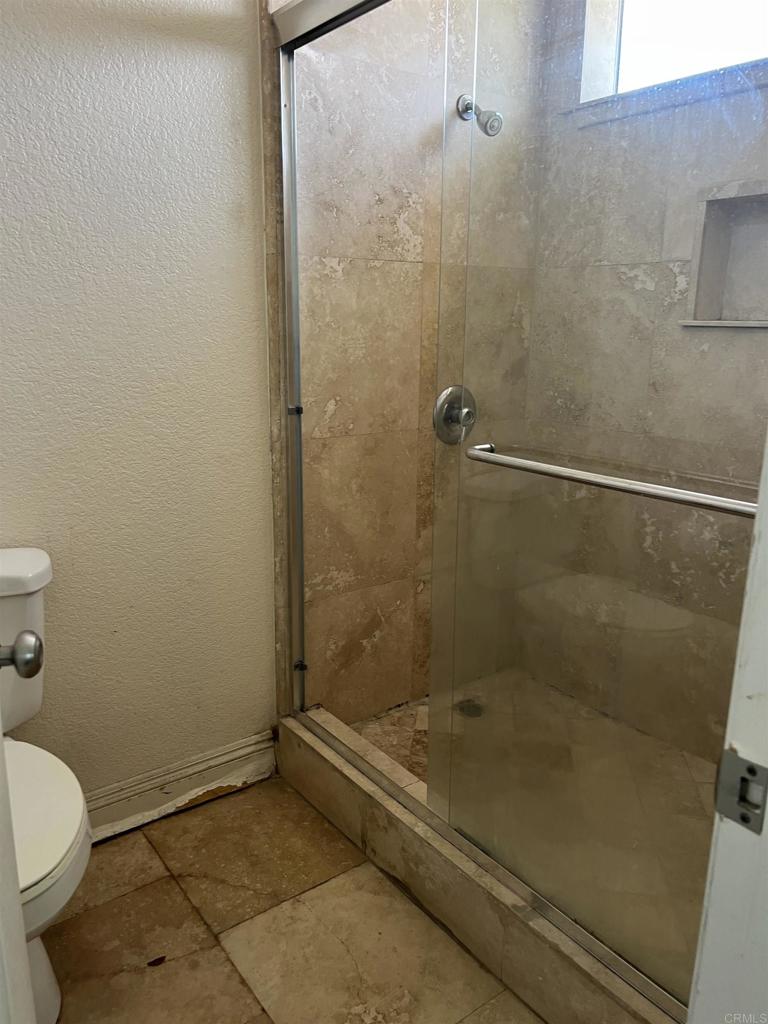 467 Cherry Hills Lane Bonita, CA 91902 - Photo 16 of 42 a bathroom with a shower and a toilet