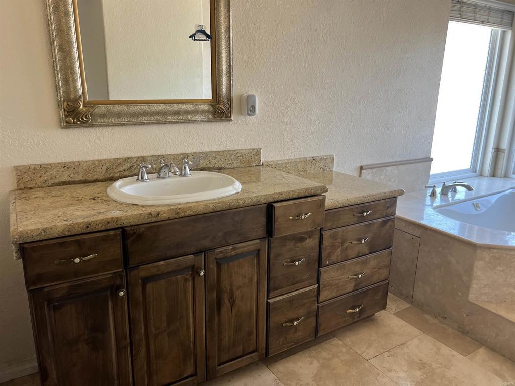467 Cherry Hills Lane Bonita, CA 91902 - Photo 20 of 42 a bathroom with a granite countertop sink and a mirror
