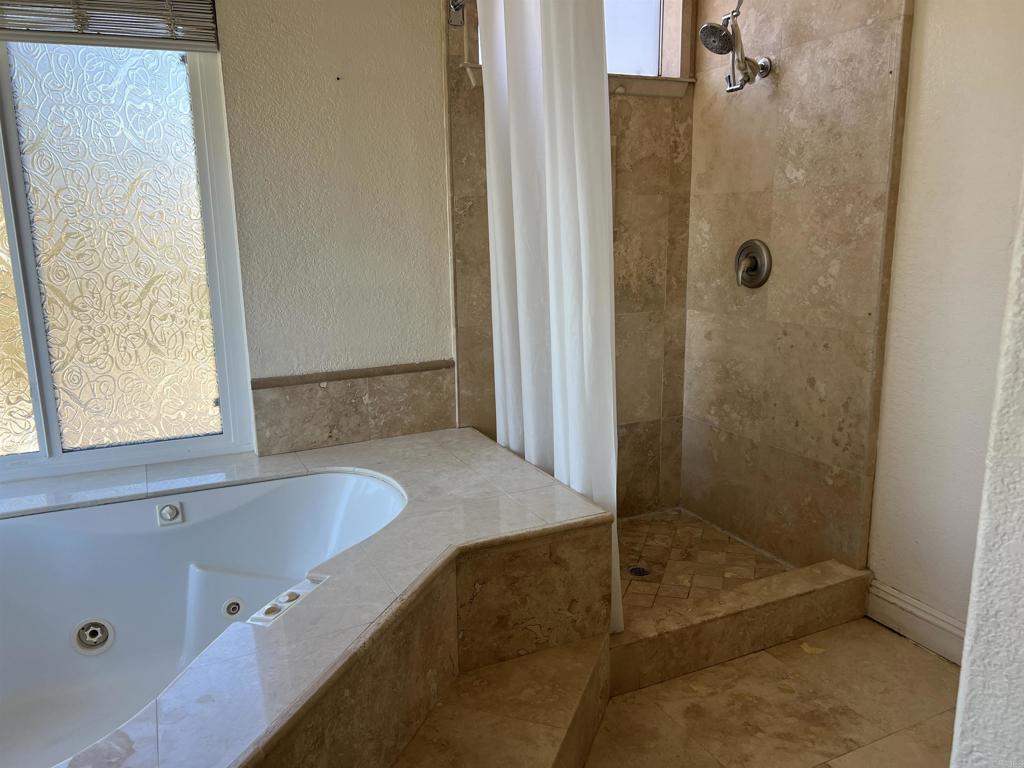 467 Cherry Hills Lane Bonita, CA 91902 - Photo 21 of 42 a bathroom with a tub and a shower