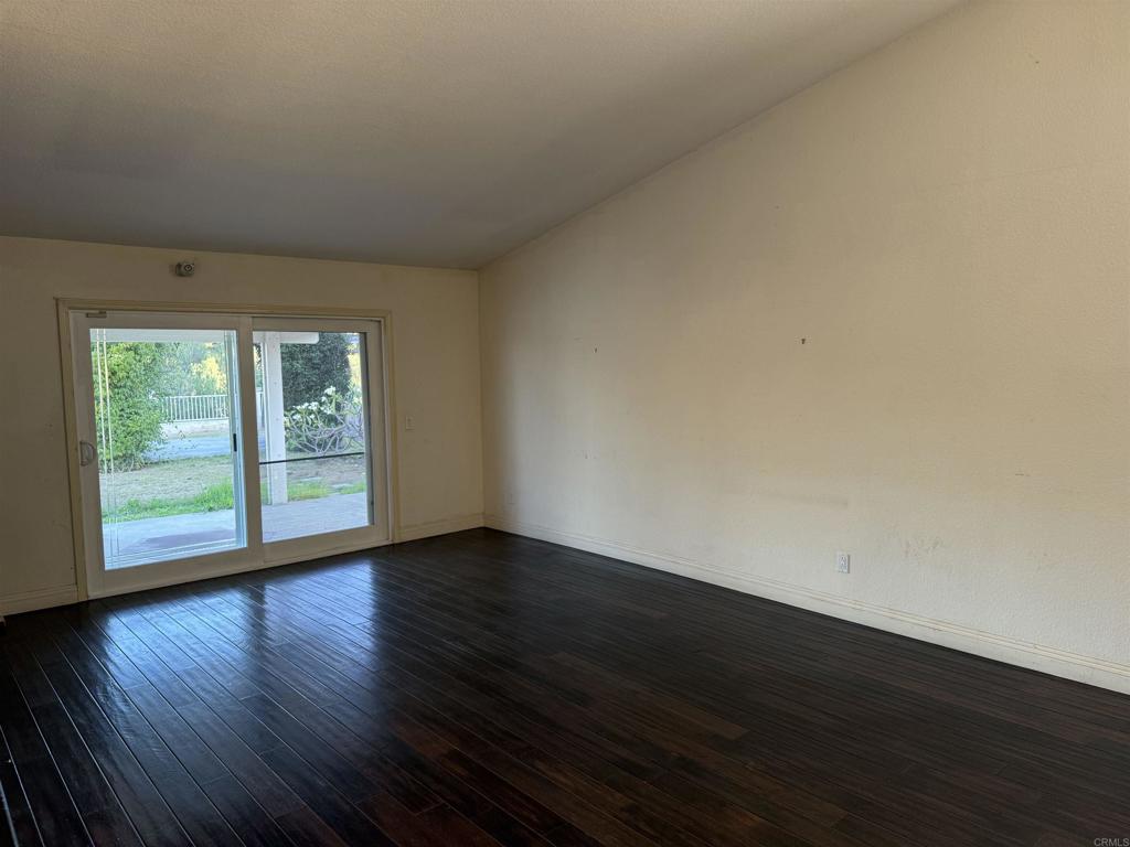 467 Cherry Hills Lane Bonita, CA 91902 - Photo 3 of 42 a view of an empty room with wooden floor and a window