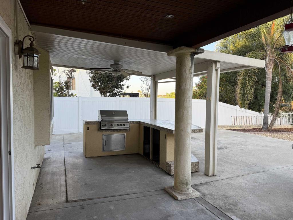 467 Cherry Hills Lane Bonita, CA 91902 - Photo 34 of 42 a kitchen with stainless steel appliances kitchen island granite countertop a table and chairs