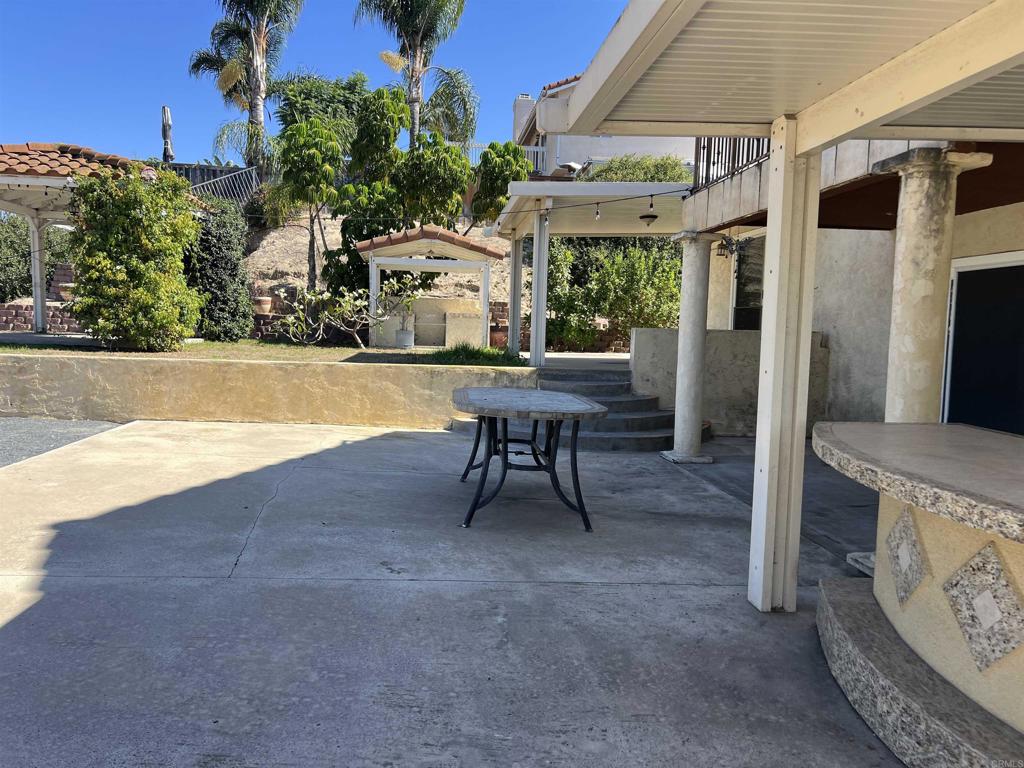 467 Cherry Hills Lane Bonita, CA 91902 - Photo 37 of 42 a view of a patio with table and chairs and potted plants