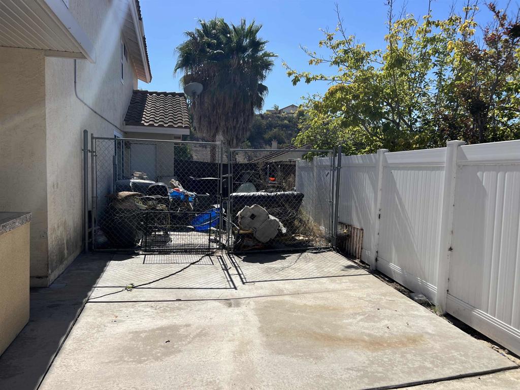 467 Cherry Hills Lane Bonita, CA 91902 - Photo 39 of 42 a view of backyard with wheel chair and potted plants