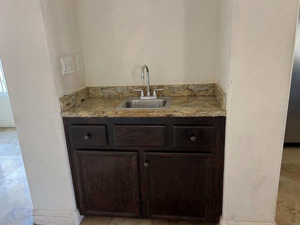 467 Cherry Hills Lane Bonita, CA 91902 - Photo 6 of 42 a bathroom with a granite countertop sink and a mirror