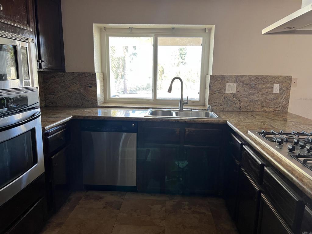 467 Cherry Hills Lane Bonita, CA 91902 - Photo 9 of 42 a kitchen with a sink stove and cabinets