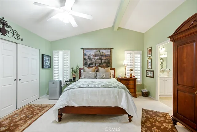 a spacious bedroom with a bed and a window
