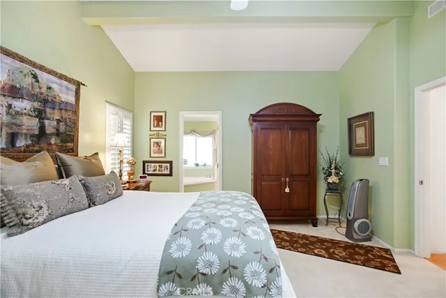 a bedroom with a bed dresser and mirror