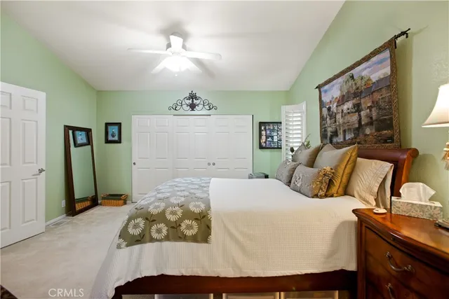 a bedroom with a large bed and a chandelier
