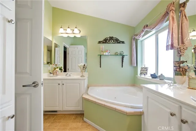 a bathroom with a tub sink and mirror