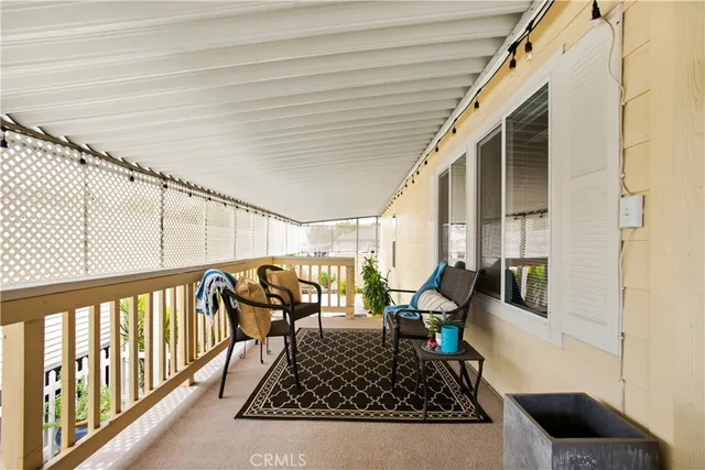 a vase of flowers sitting on a floor in front of a door
