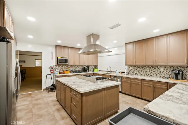 a living room with furniture a fireplace and a chandelier