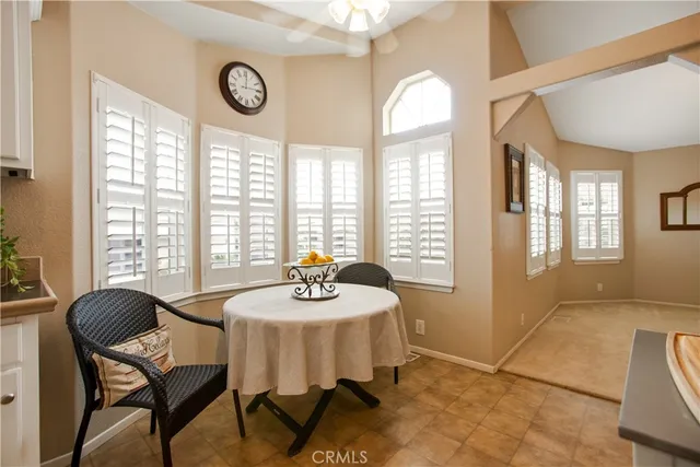a view of a dining room with furniture and a large window