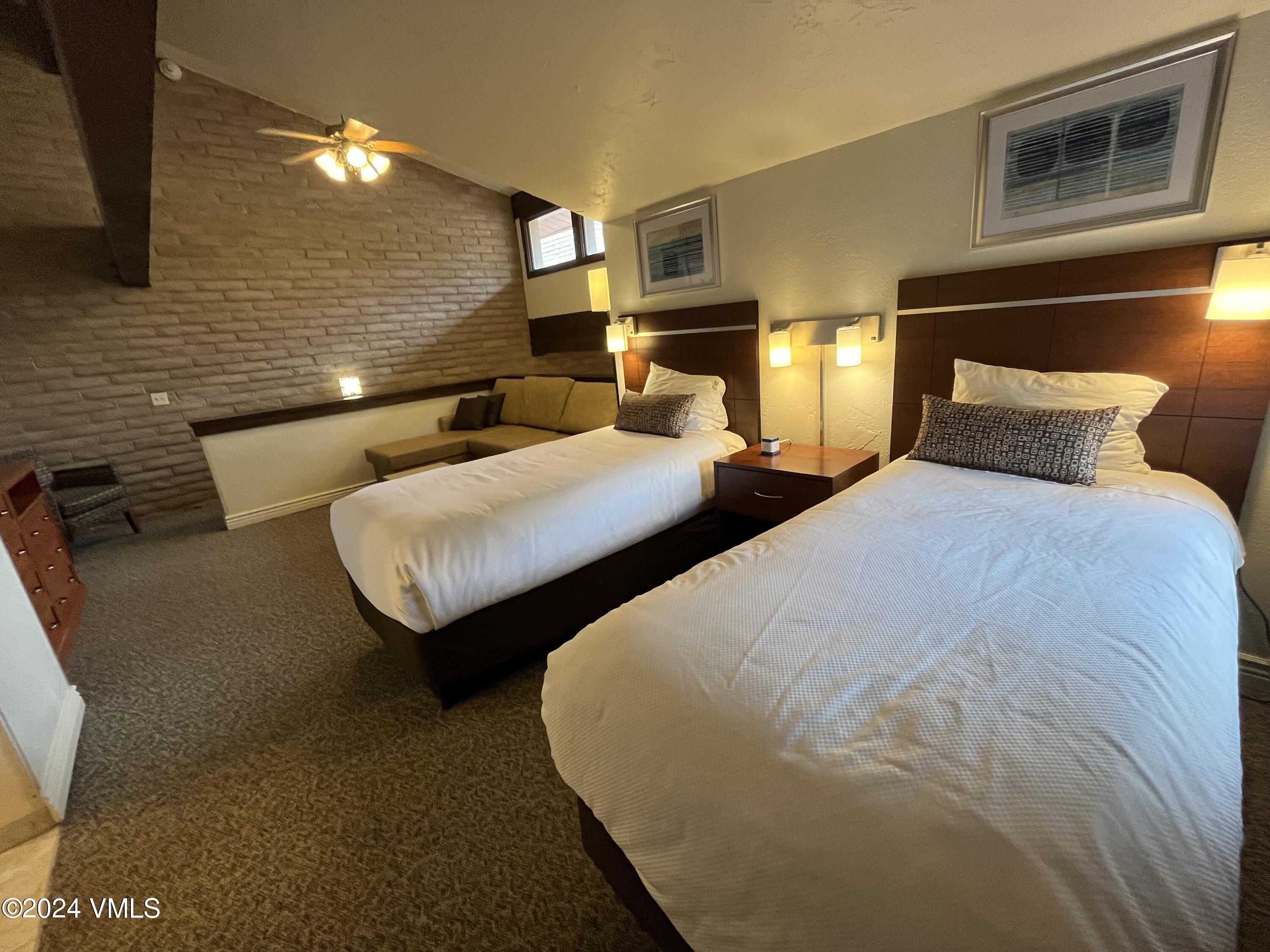 1020 Vail View Drive, Unit 341227 Vail, CO 81657 - Photo 12 of 26 a bedroom with two beds and painted walls