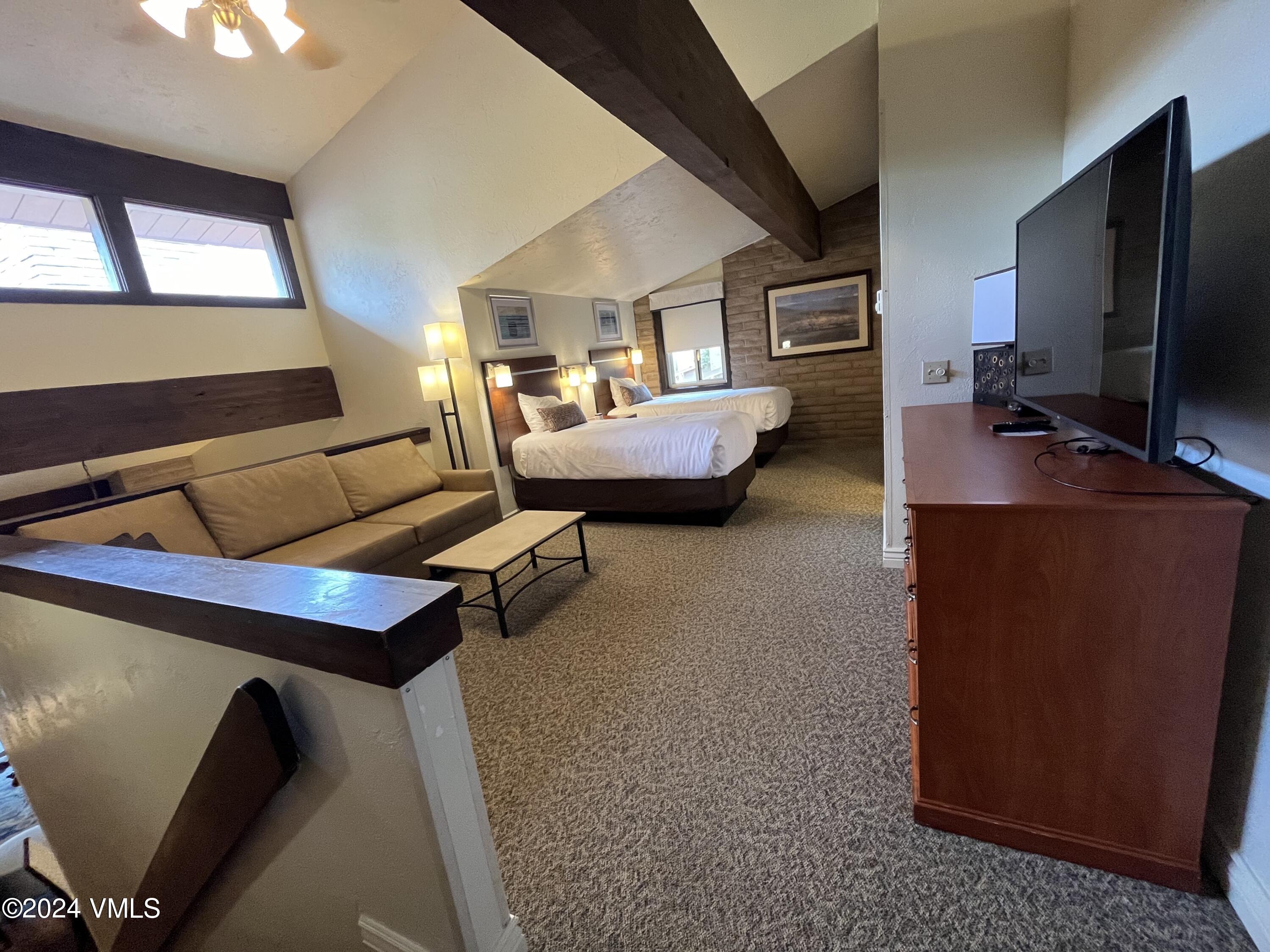 1020 Vail View Drive, Unit 341227 Vail, CO 81657 - Photo 10 of 26 a living room with furniture and a flat screen tv